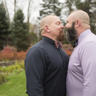 Engagement session for same sex couple - photo of two men facing each other and moving in for a kiss