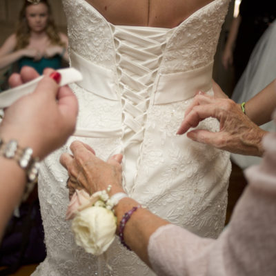 Lacing up bride's dress - Ann Arbor, Michigan Wedding Photographer