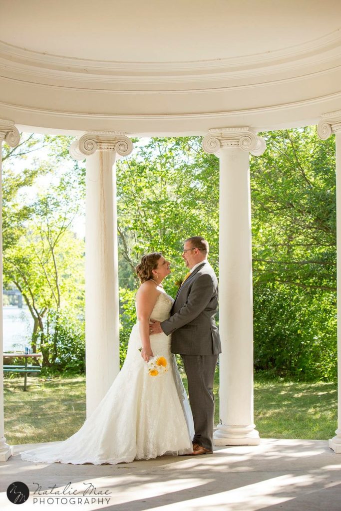 Island Park Ann Arbor wedding couple stands in the Greecian inspired pavillion.