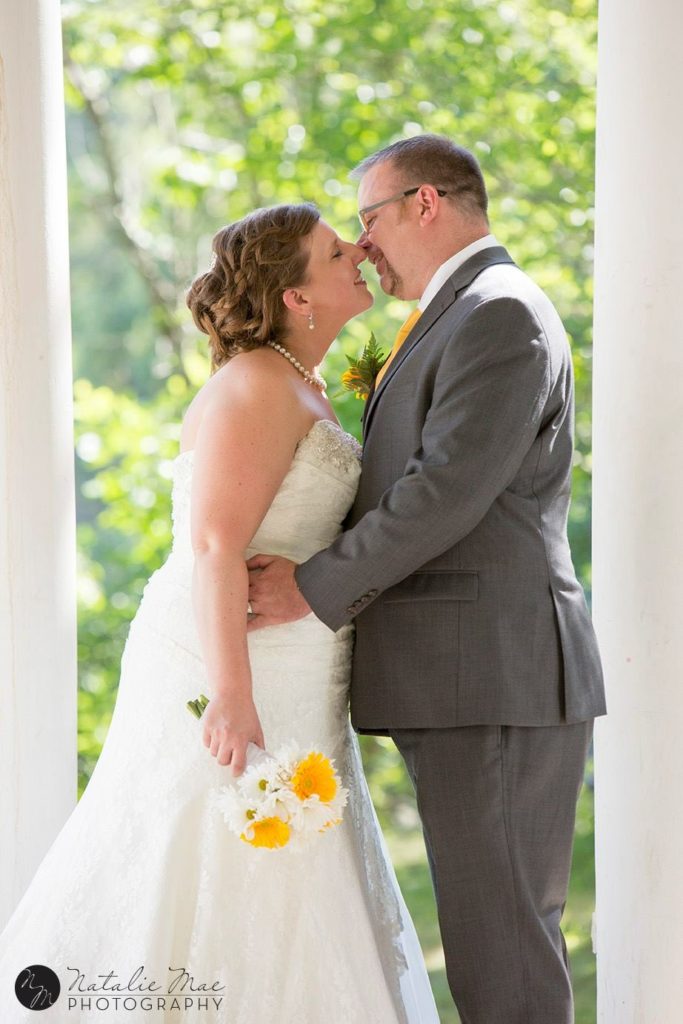 Island Park Ann Arbor wedding couple kisses next to the Huron River