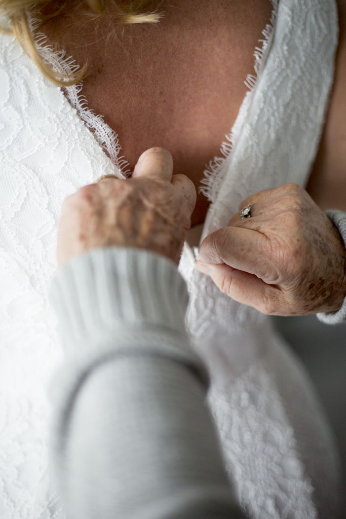 Mom helps bride zip up her dress before her Chelsea Michigan elopement