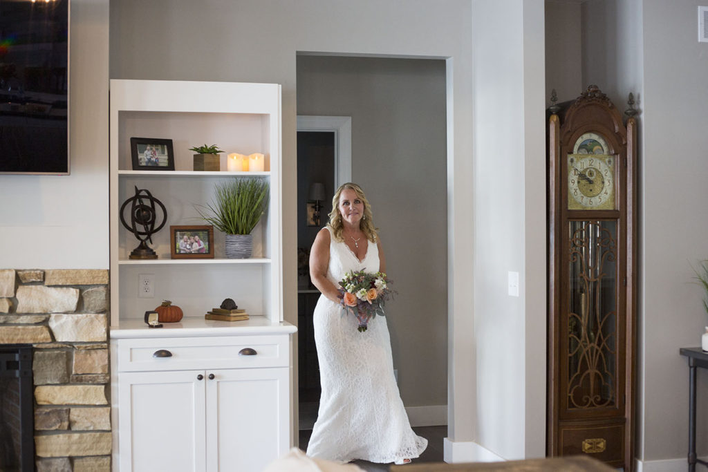 Bride walks around the corner to see her groom for the first time on their wedding day