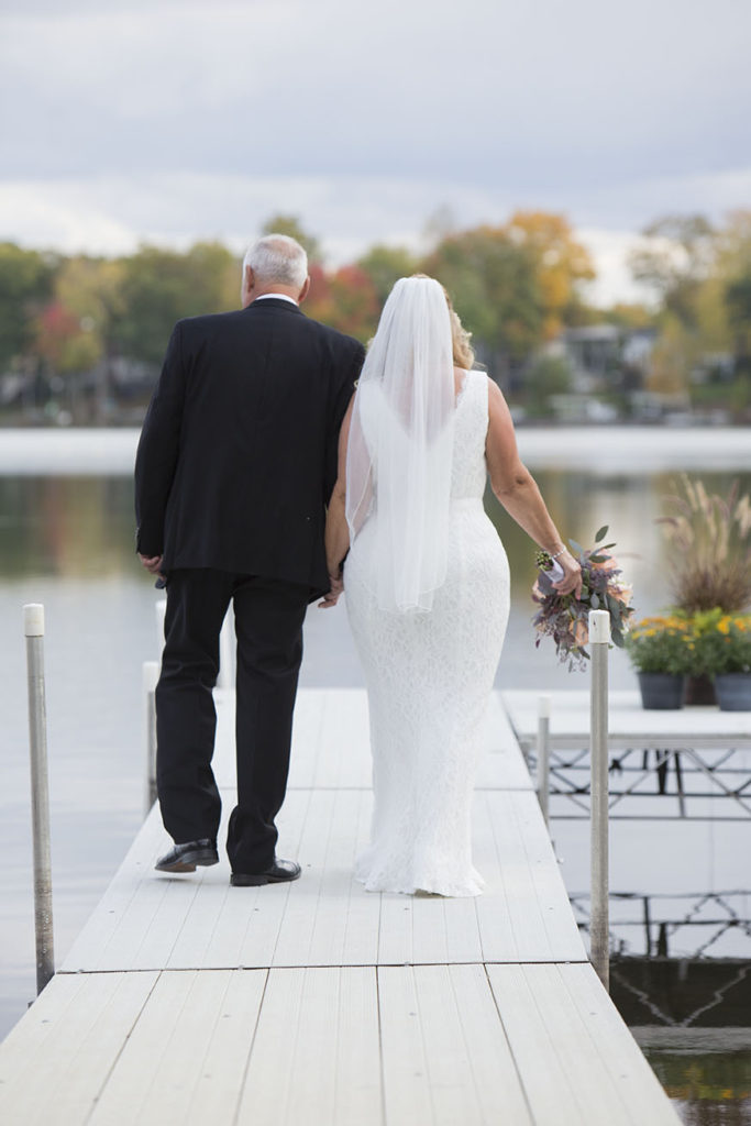 Couple walks towards the end of the dock