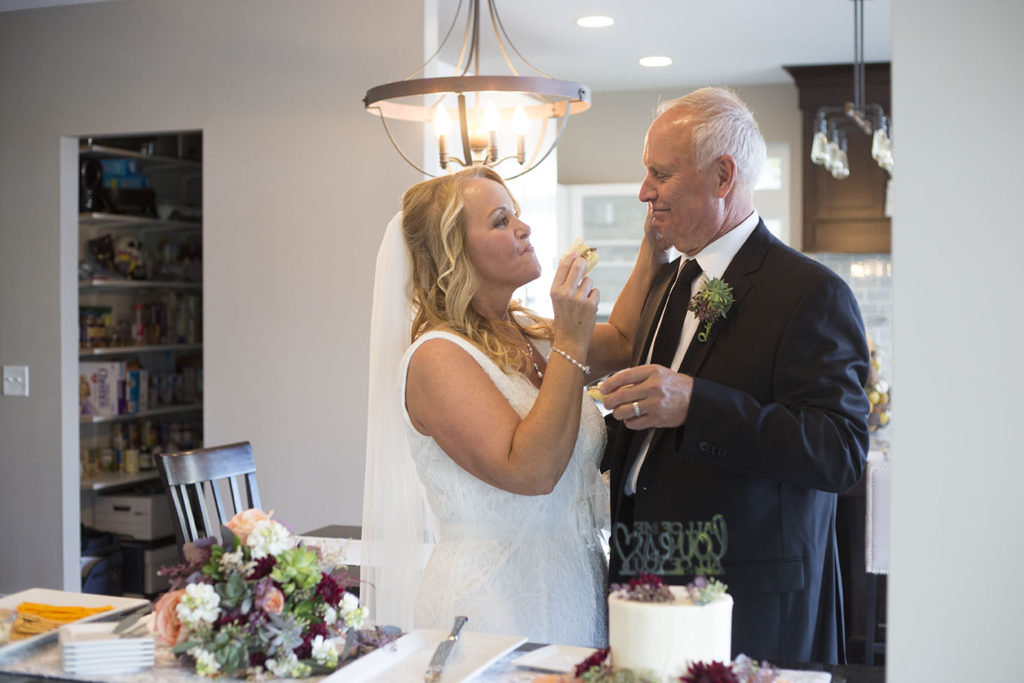 Michigan elopement couple feeding each other cake