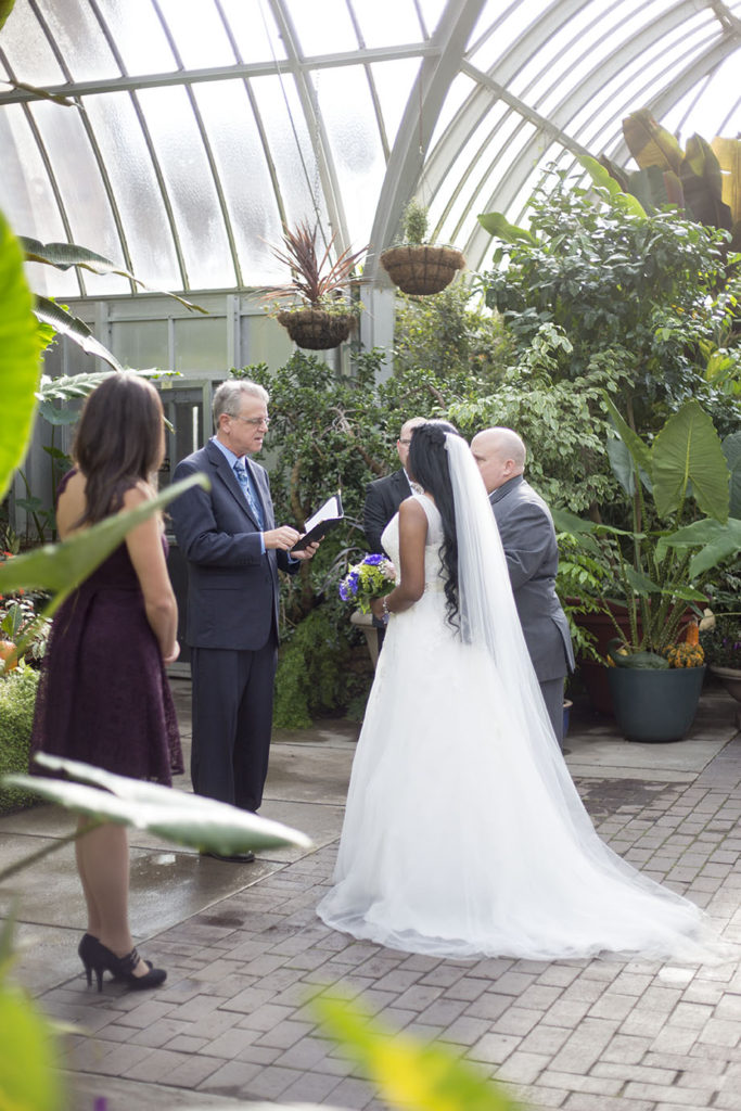 Couple stands in front of the officiant at their Belle Isle wedding