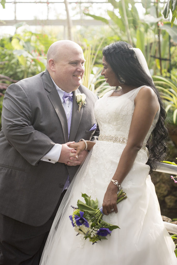 Couple looks at each other in the Tropic House on Belle Isle