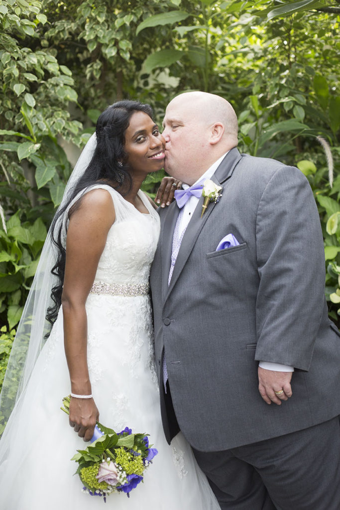 Detroit groom kisses his Michigan Indian bride