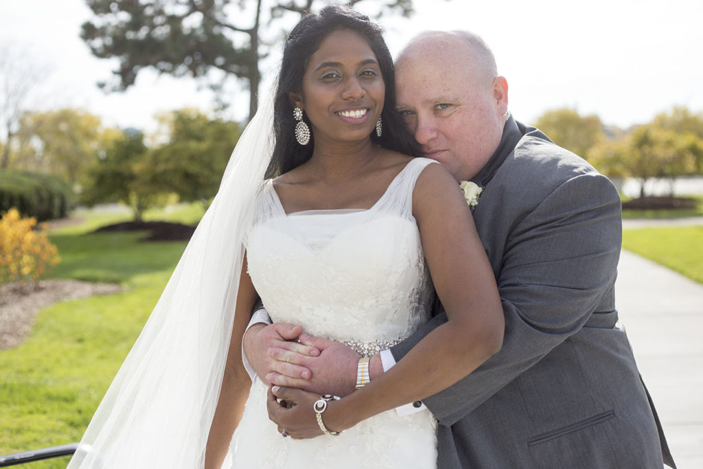 Couple cuddles after their Belle Isle wedding in Detroit