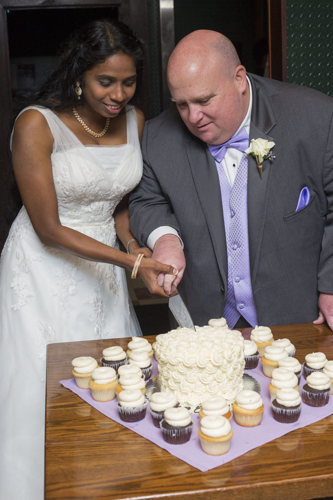 Wedding couple cut the cake at their Detroit wedding