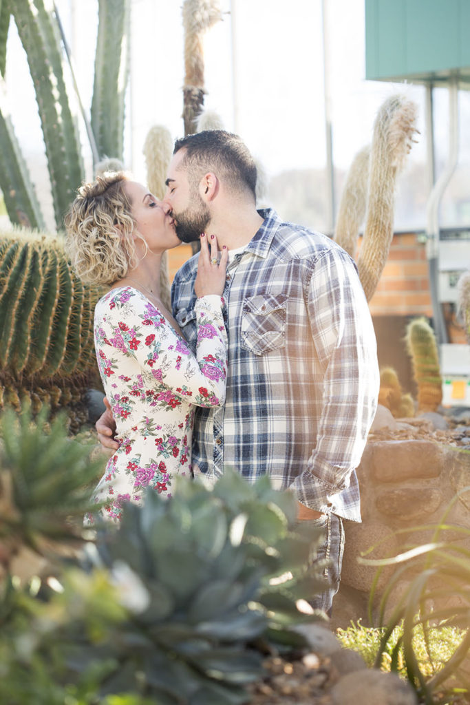 Couple-hold-hands-in-the-tropical-house