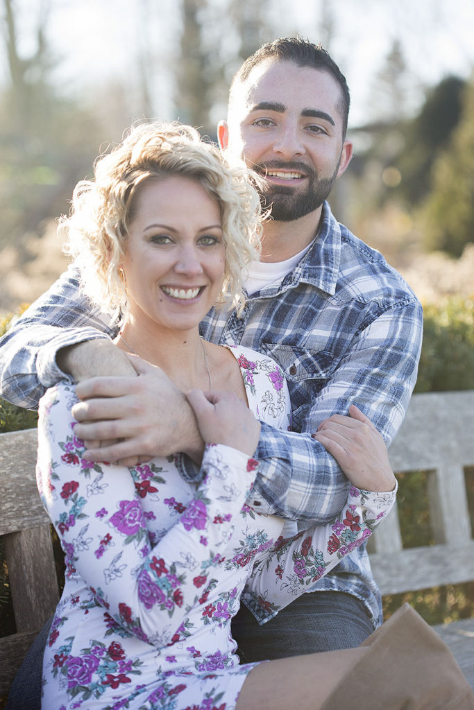 Cuddling up to say warm for their outdoor December couples session