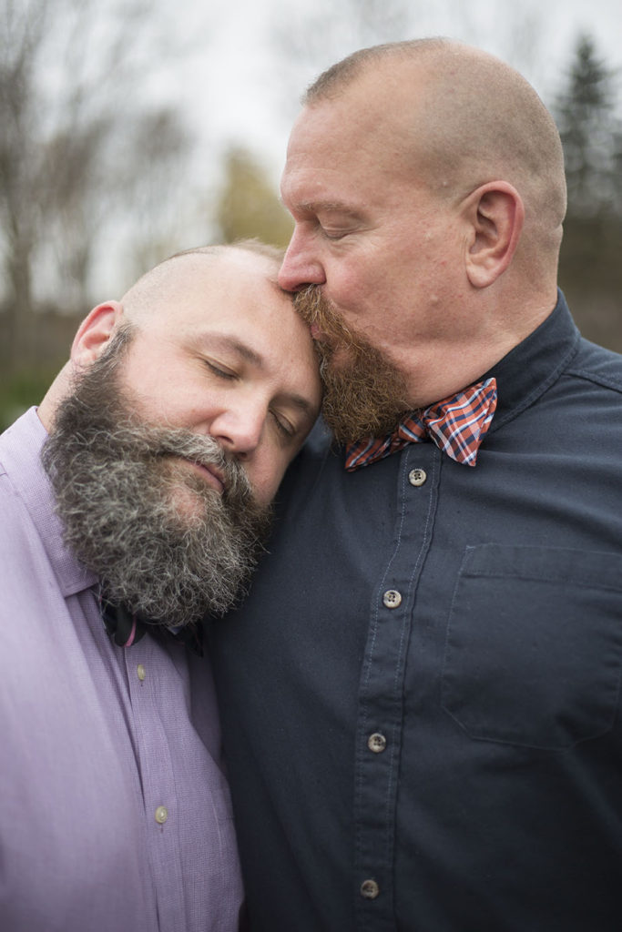 LGBTQ couple cuddle after their Ann Arbor micro wedding