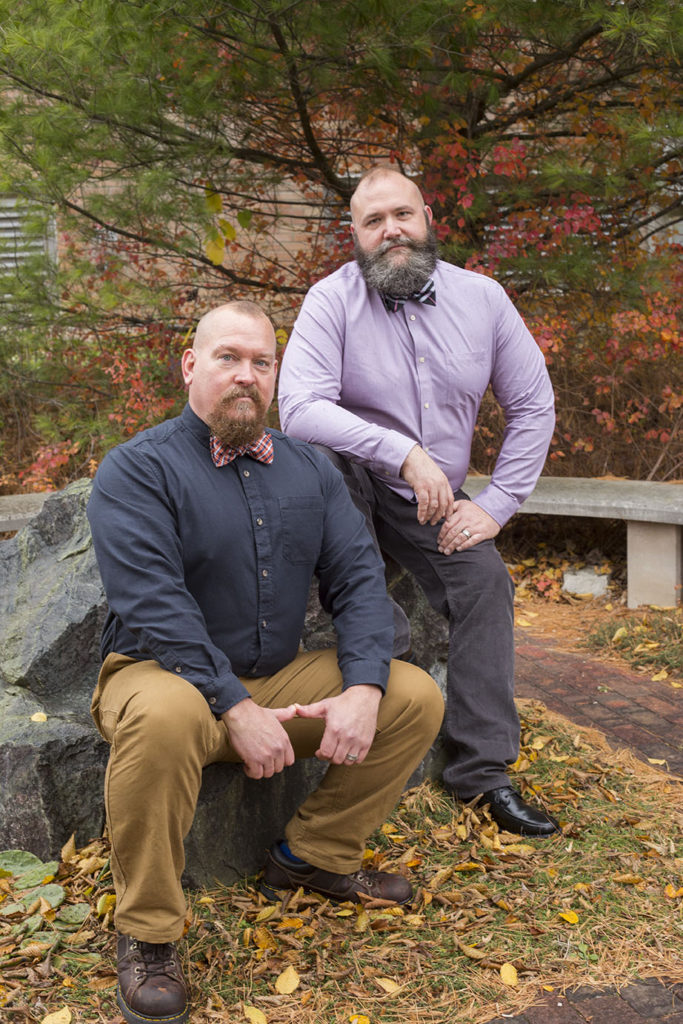 Colorful fall leaves around Michigan gay wedding couple