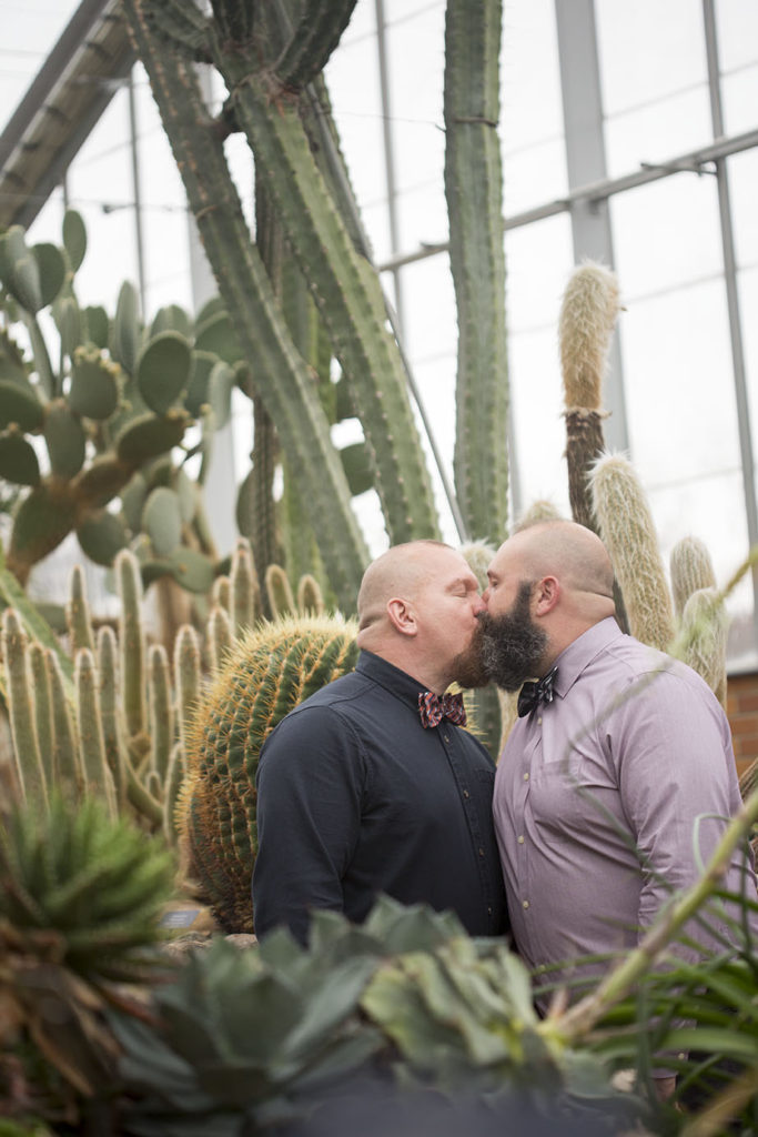 Ann Arbor micro wedding couple kisses in the Arid House at Matthaei Botanical Gardens