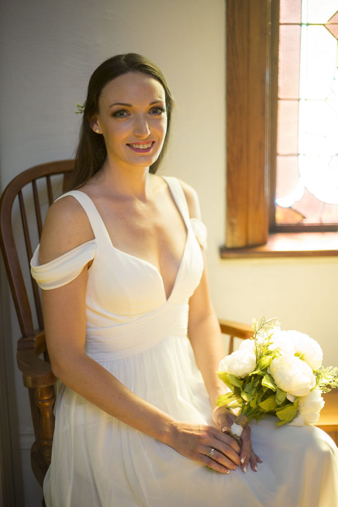 Bride sitting in a rocking chair at Celebrations Wedding Chapel