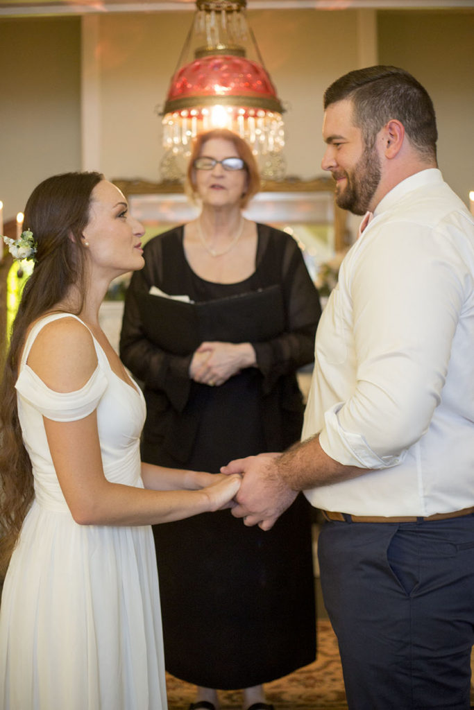 Couple holding hands while exchanging their vows