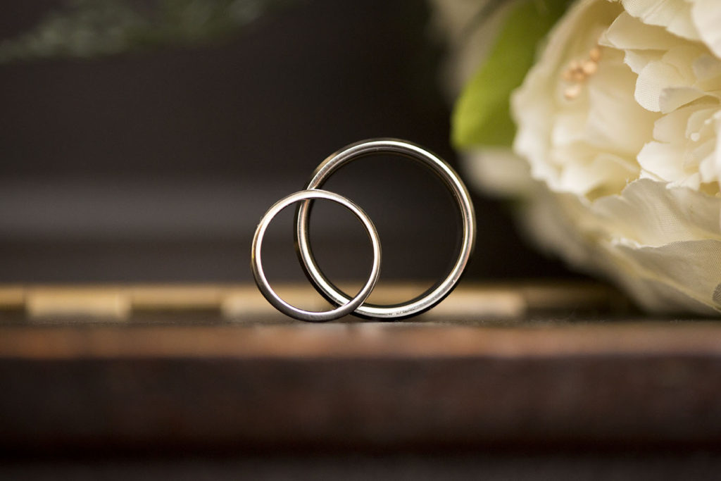 Wedding rings on top of piano