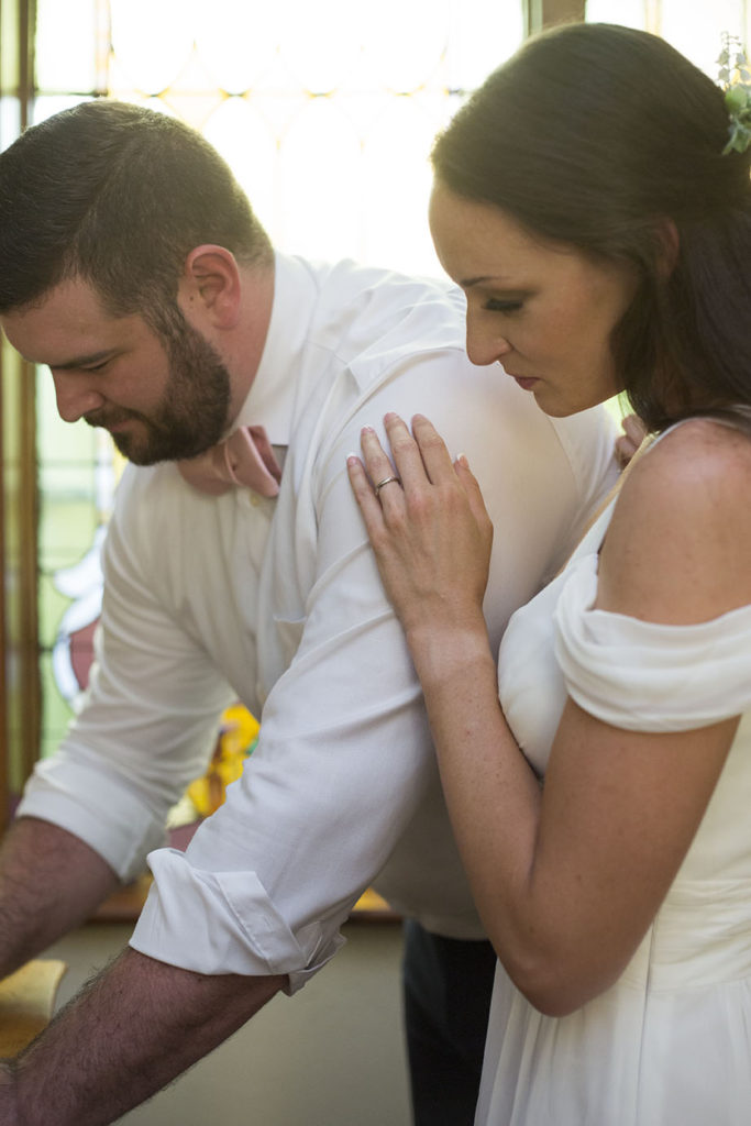 Groom signing the marriage certificate inside the historic chapel