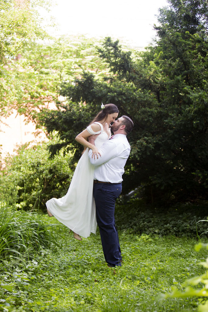 Groom lifts bride into the air