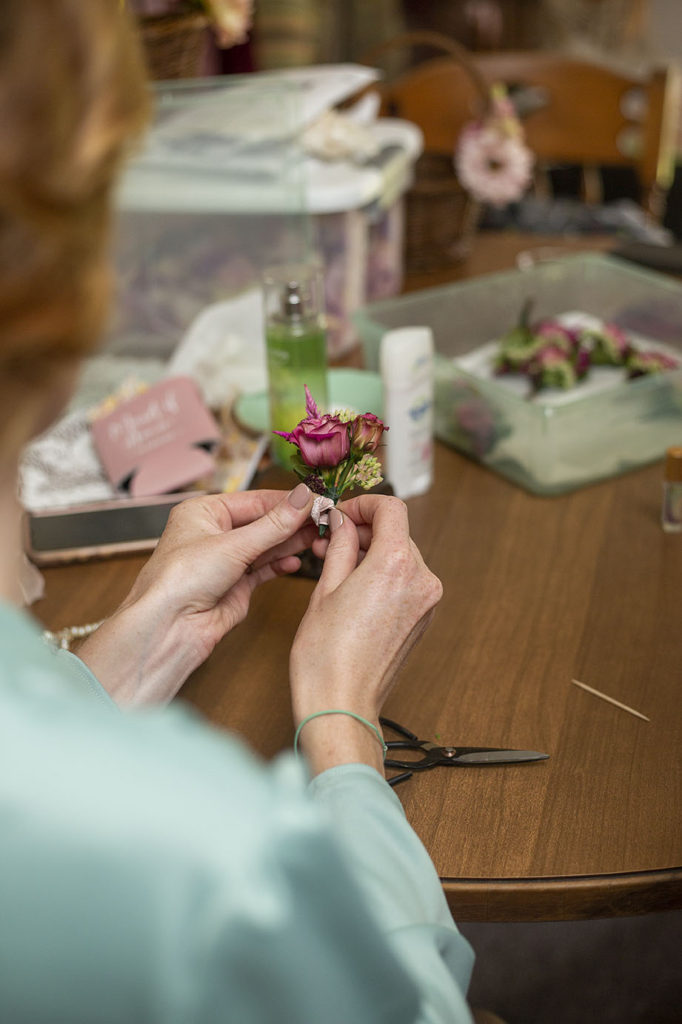 Finishing touches on Belleville wedding boutonnieres