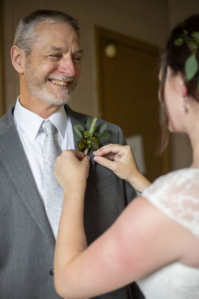 Rachel pins on her father's boutonniere 