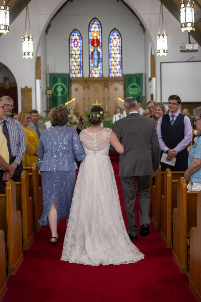 Northville bride walking down the aisle with her parents