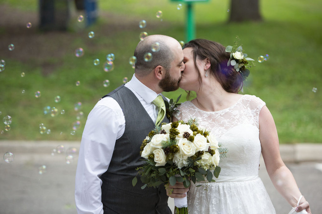 Wedding couple surrounded by bubbles