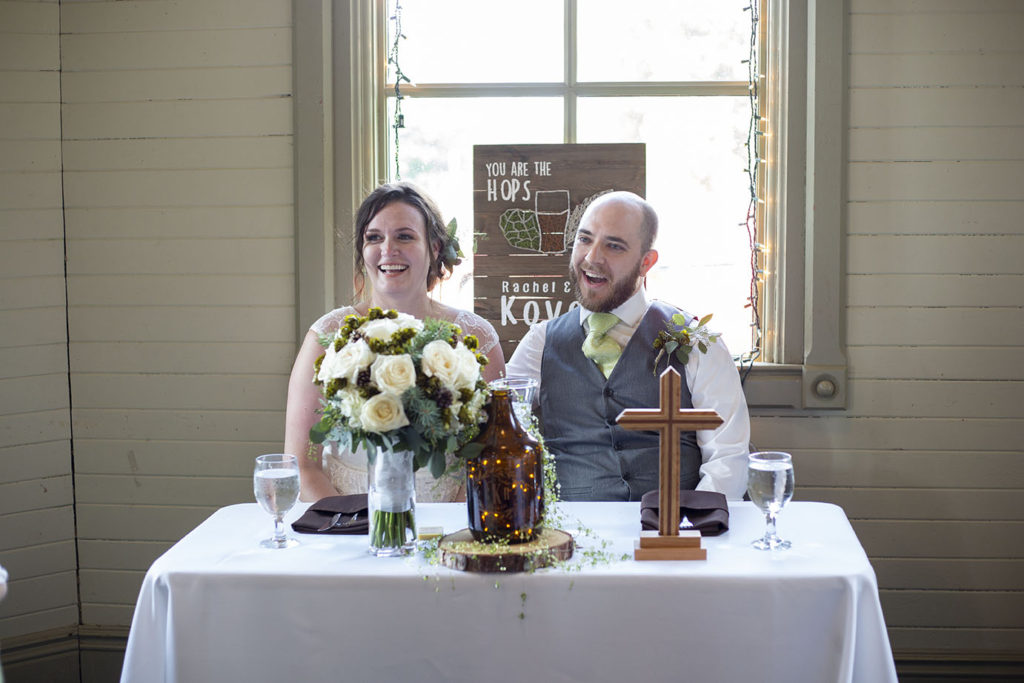 Corey and Rachel sitting at the head table of their Chelsea wedding