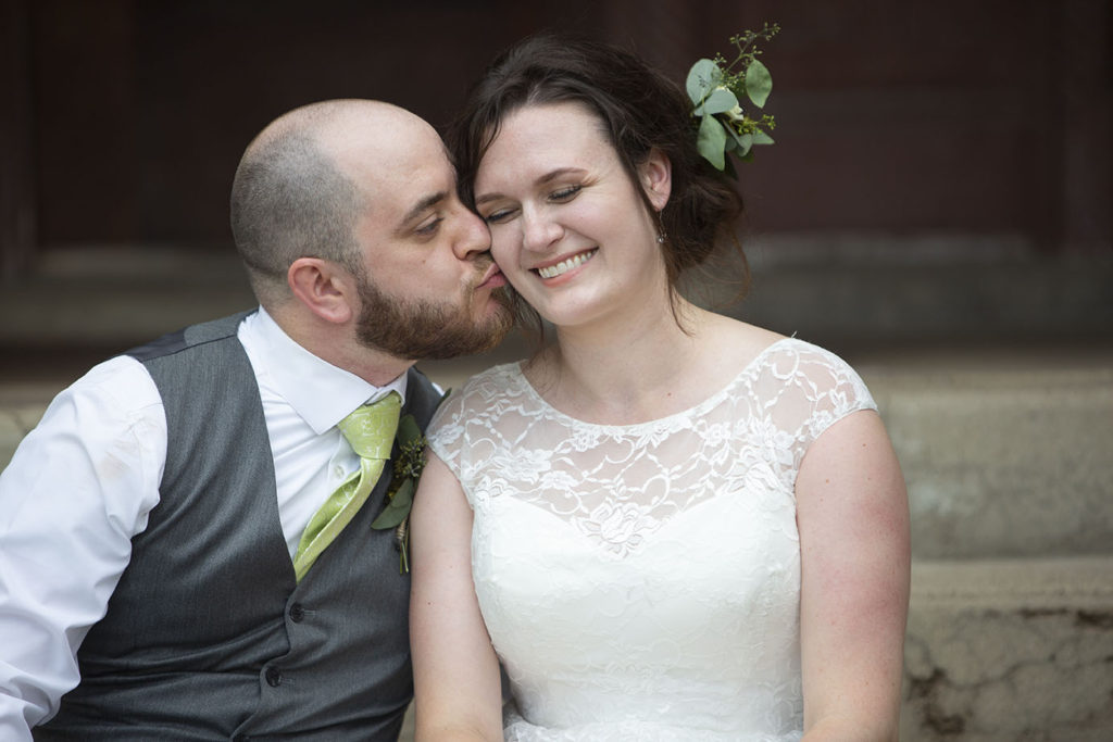 Couple kisses on steps in front of Chelsea Depot