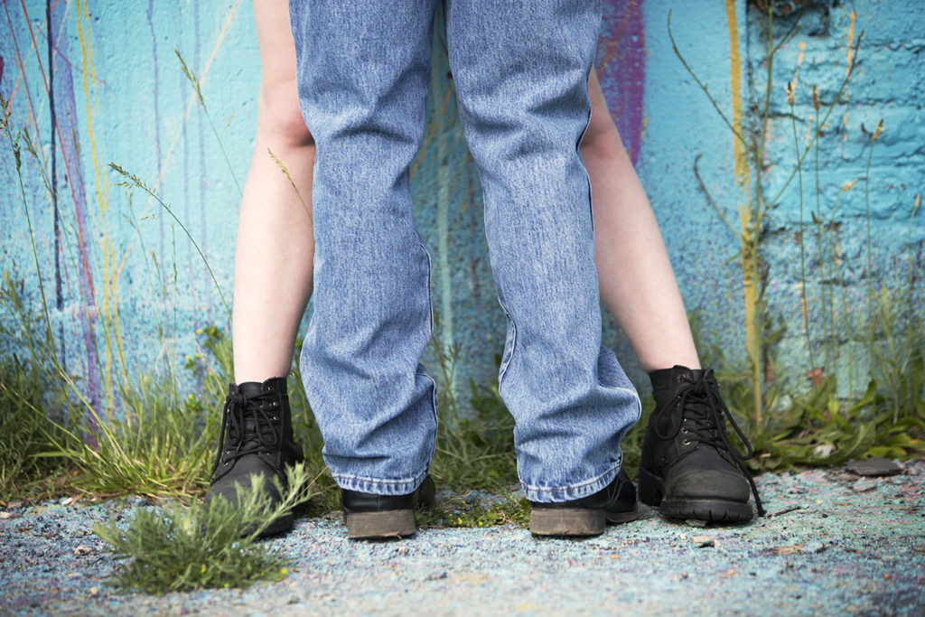 Couple kisses up against a wall in Detroit