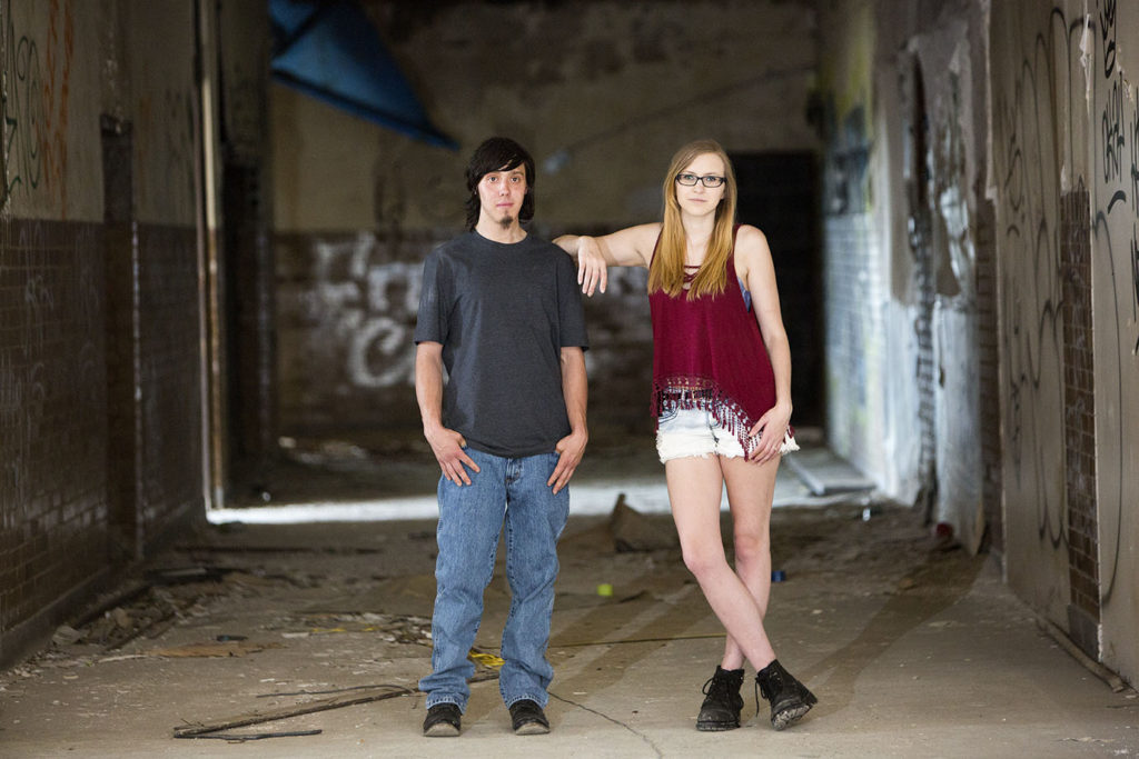 Couple poses in hallway during their Detroit urbex engagement session