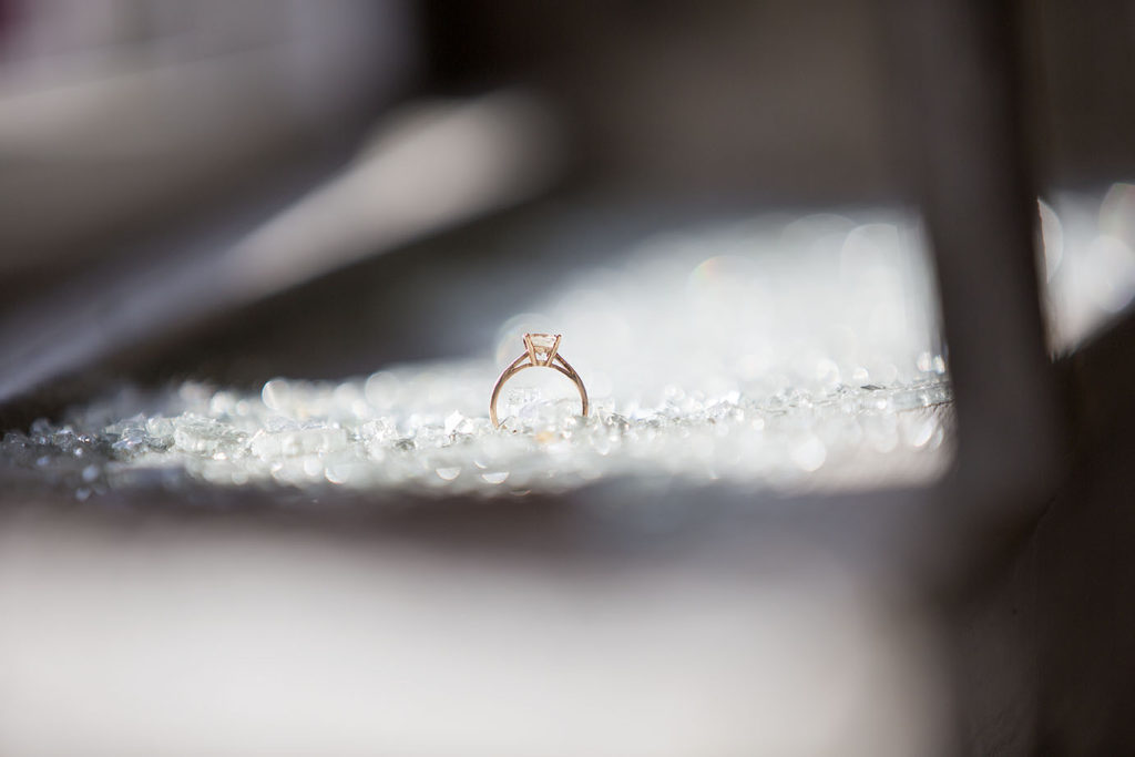 Engagement ring amongst shattered glass in abandoned building