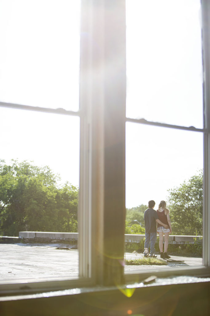 Couple walks on roof for their Detroit urbex engagement session