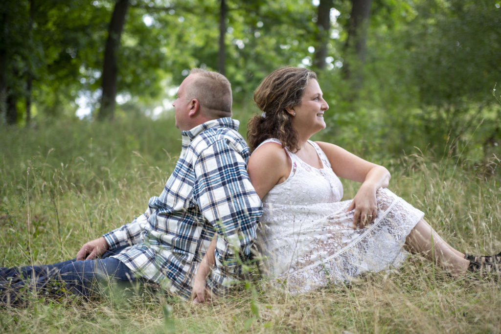 Couple sits back to back for their Dexter engagement session