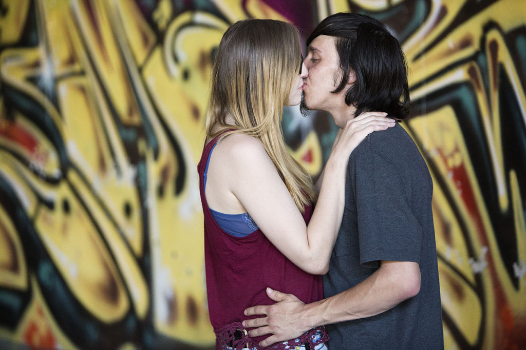 Detroit couple in front of yellow graffiti