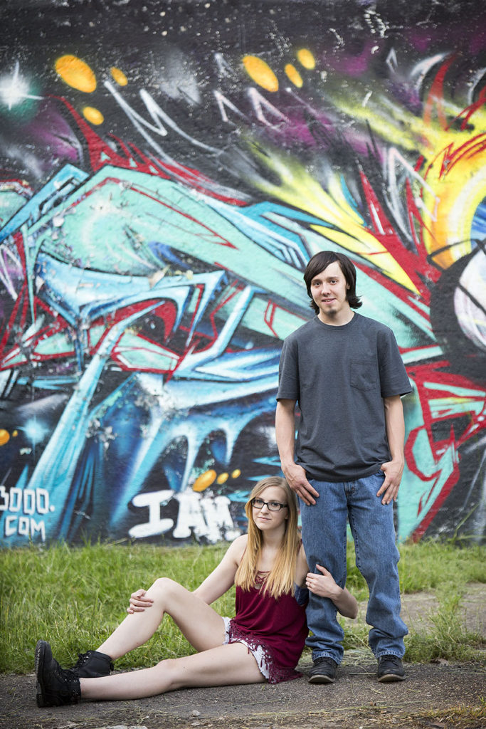 Detroit urbex engagement session cuddling up in front of graffiti