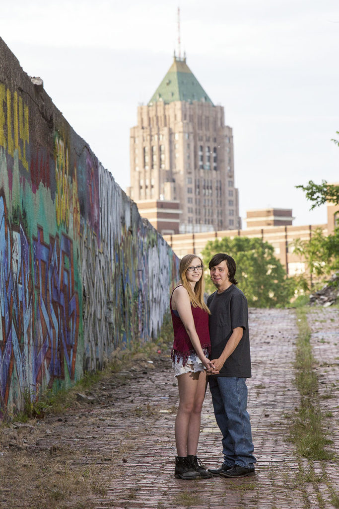 Michigan engaged couple with Detroit skyline in the background