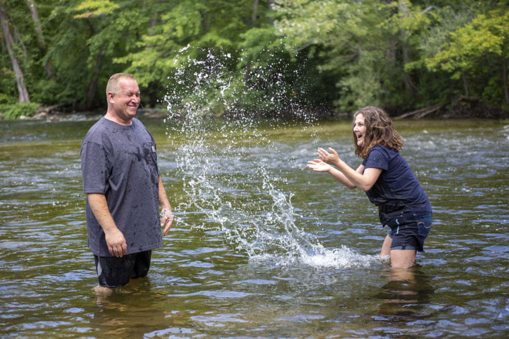 Lola splashing Chris in the Huron River