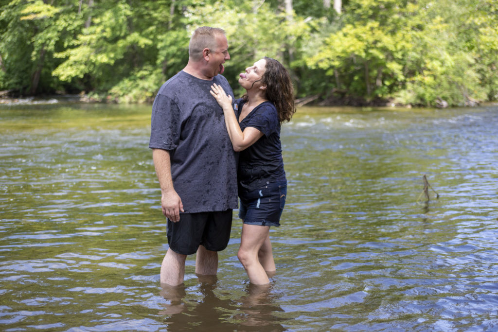 Couple stands together in the river