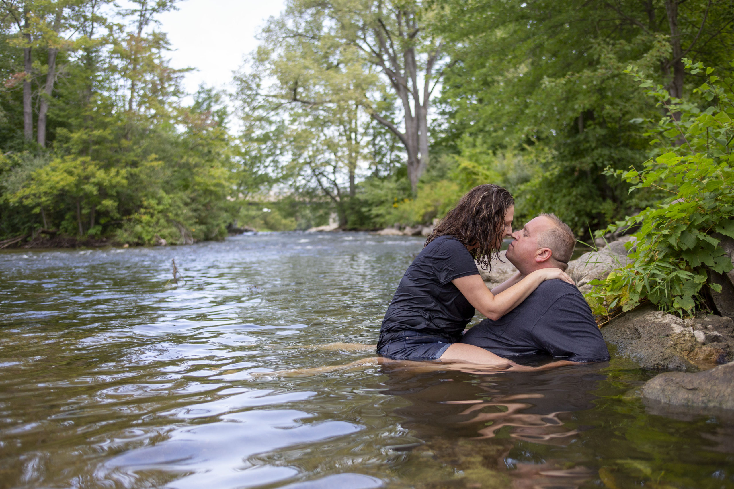 Wide angle of the Huron River and the Michigan engaged couple - how to stay cool during your photo session