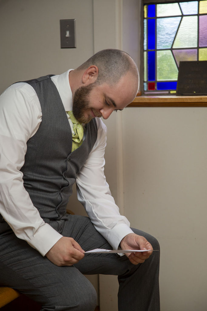 Groom reading letter from his bride