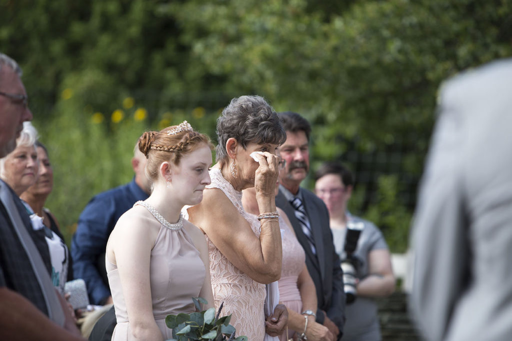 Mother of the bride crying as her daughter gets married.