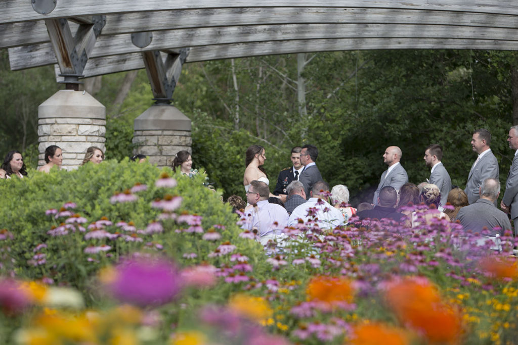 Bride and groom get married amongst a sea of flowers at Matthaei Botanical Gardens