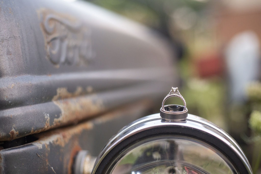 Howell wedding rings atop a rusted tractor