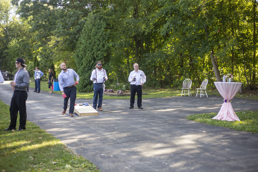 Guest playing cornhole before wedding