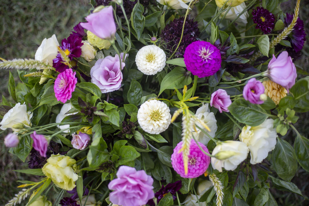 A floral arrangment in fuchsia and white