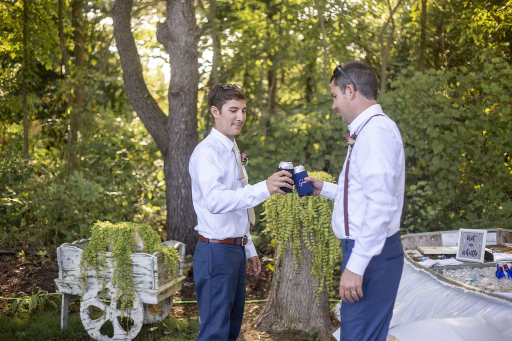 Groom and groomsman toasting