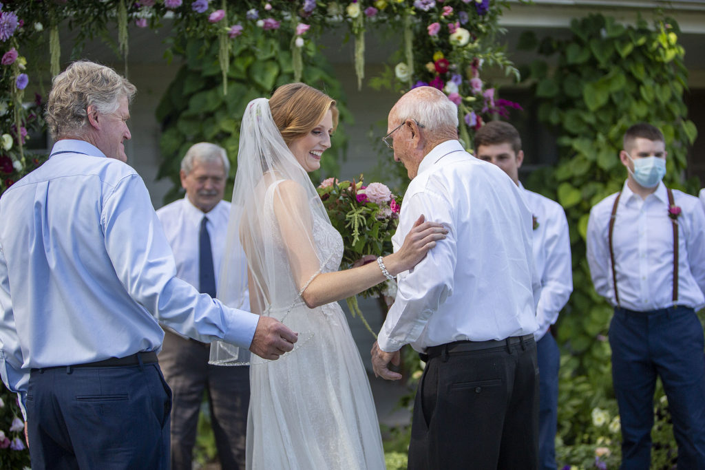 Bride getting handed off by grandfather