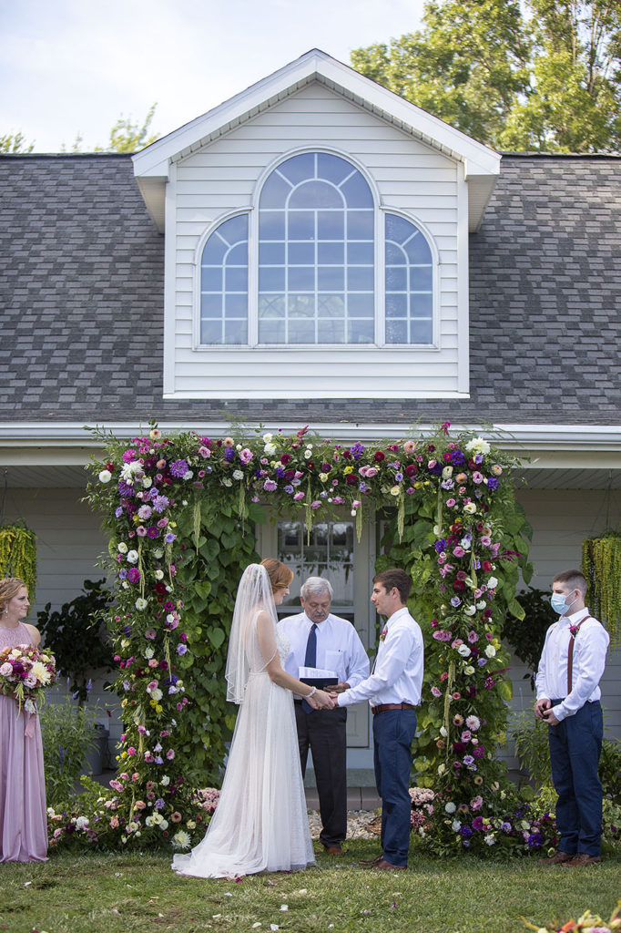 Couple holds hands at their Belleville wedding