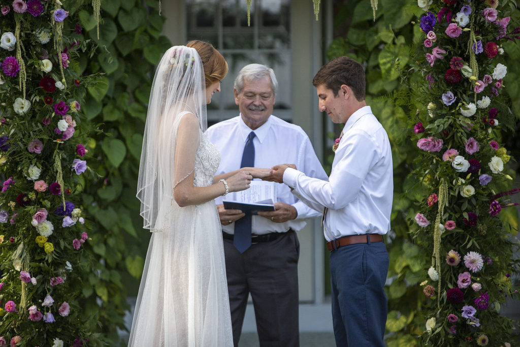 Groom puts ring on brides hand